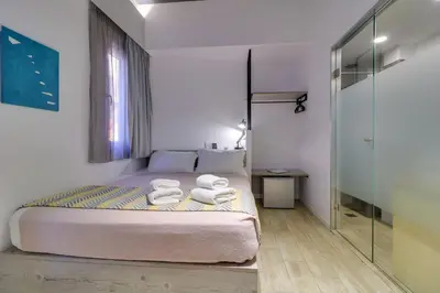 a bedroom with a bed with two towels on it at athensotel in Athens