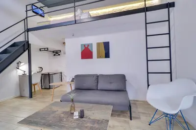 a living room with a couch and a loft bed at athensotel in Athens