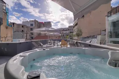 a hot tub on the roof of a building at athensotel in Athens