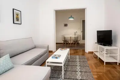 a living room with a couch and a table at Truman Apartment - Athens in Athens