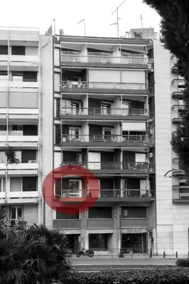 a large apartment building with a red object in front of it at Truman Apartment - Athens in Athens