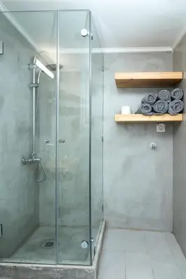a shower with a glass door in a bathroom at Truman Apartment - Athens in Athens