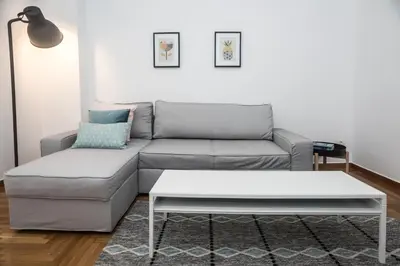 a living room with a couch and a coffee table at Truman Apartment - Athens in Athens