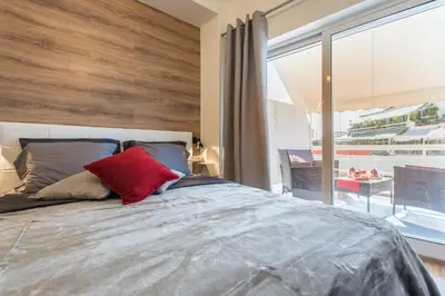 a bedroom with a large bed with a red pillow at Athenz Downtown Studio in Athens