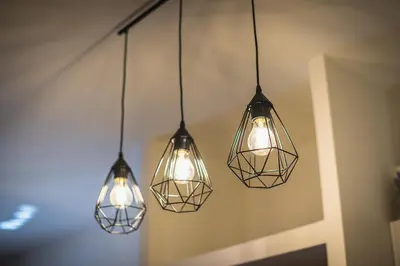 a group of three lights hanging from a wall at Athenz Downtown Studio in Athens
