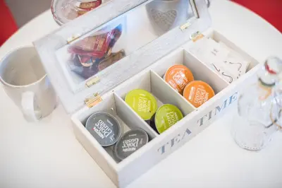 a box filled with different colored buttons on a table at Athenz Downtown Studio in Athens