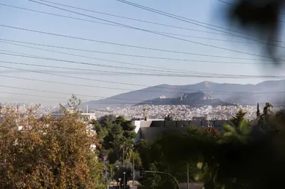 a view of a city with a mountain in the background at Romeo & Juliet -Modern & Stylish Apartment With City View in Egaleo-Athens in Athens