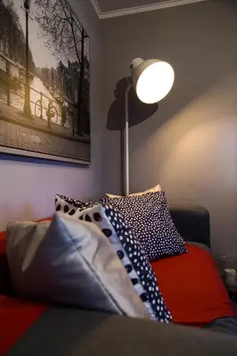 a room with a bed with a lamp and pillows at Romeo & Juliet -Modern & Stylish Apartment With City View in Egaleo-Athens in Athens