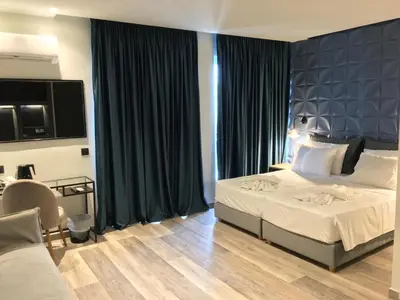 a hotel room with two beds and a television at Athens coast hotel in Athens