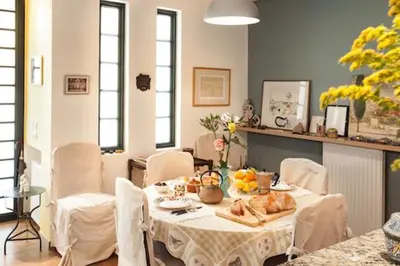 a dining room with a table with food on it at Maison de Famille in Athens