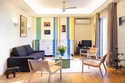 a living room with a couch and a table at Maison de Famille in Athens
