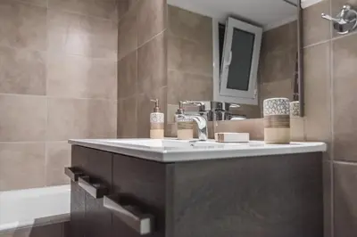 a bathroom with a sink and a mirror and a tub at On the way to Ithaca in Athens