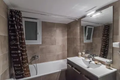 a bathroom with a tub and a sink and a mirror at On the way to Ithaca in Athens