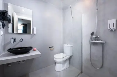 a bathroom with a toilet and a glass shower at Enattica Monastiraki Living in Athens