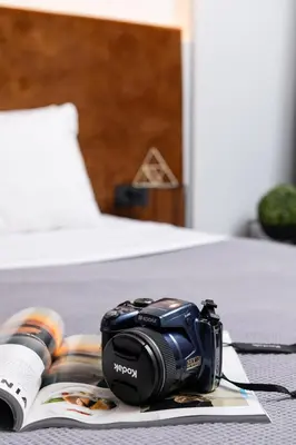 a camera sitting on top of a book on a bed at Enattica Monastiraki Living in Athens