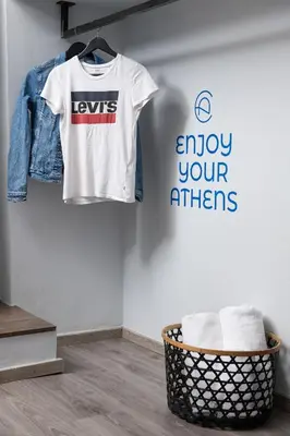 a t shirt and a jacket hanging on a wall at Enattica Monastiraki Living in Athens