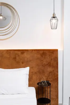 a bedroom with a white bed and two lights at Enattica Monastiraki Living in Athens