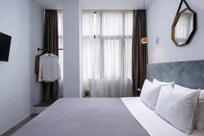 a bedroom with a large white bed with white pillows at Enattica Monastiraki Living in Athens