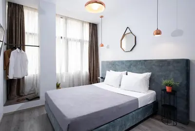 a bedroom with a large bed and a window at Enattica Monastiraki Living in Athens