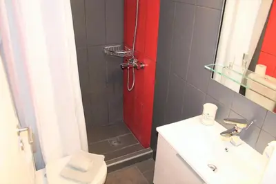 a bathroom with a shower and a toilet and a sink at Apartment SEA VIEW in front of the beach of Agia Marina in Porto Rafti