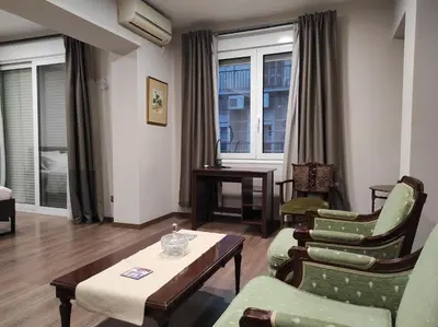 a living room with chairs and a table and windows at Athens Center Spacious Luxury Apartment in Athens