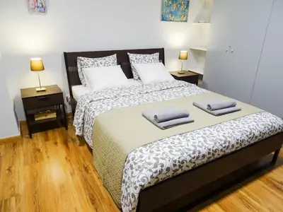 a bedroom with a bed with two pillows on it at Athens Center Spacious Luxury Apartment in Athens