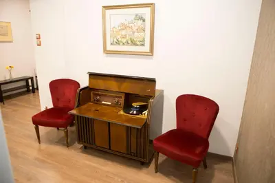 a room with two red chairs and an old machine at Athens Center Spacious Luxury Apartment in Athens