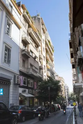 a busy city street with buildings and a motorcycle at Athens Center Spacious Luxury Apartment in Athens