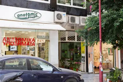 a car parked in front of a store on a street at Athens Center Spacious Luxury Apartment in Athens