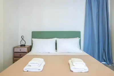 a bedroom with a bed with two towels on it at Sunny studio with Starlight balcony in Athens