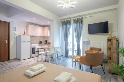 a kitchen and living room with a table and chairs at Sunny studio with Starlight balcony in Athens