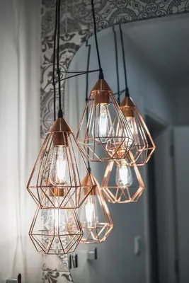 a chandelier with many lights in front of a mirror at 