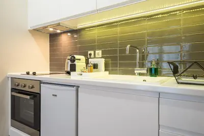a kitchen with a sink and a mirror at 