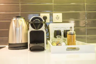 a kitchen counter with a coffee maker next to a box at 