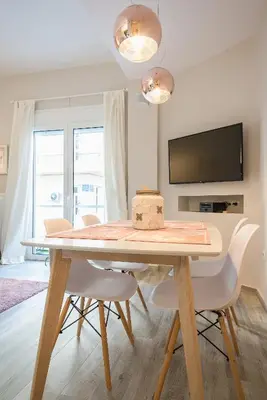 a dining room with a table with chairs and a tv at 