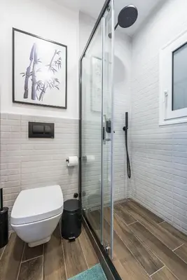 a bathroom with a toilet and a glass shower at 
