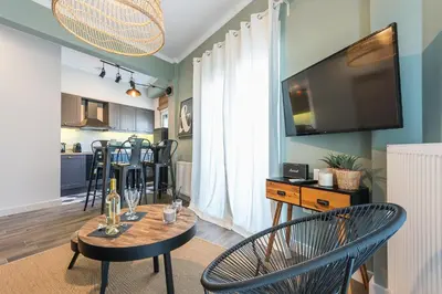 a living room with a table and chairs and a television at 
