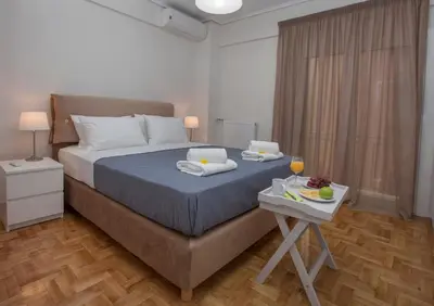 a bedroom with a bed and a table with food on it at Unique Apartment close to Acropolis by GHH in Athens