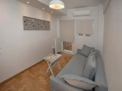 a living room with a couch and a table at Unique Apartment close to Acropolis by GHH in Athens