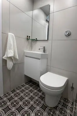 a white bathroom with a toilet and a sink at Unique Apartment close to Acropolis by GHH in Athens