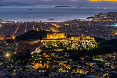 an aerial view of the acropolis at night at Sweet stone apartment in Imittos in Athens