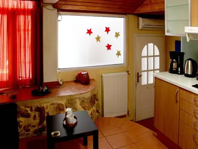 a kitchen with a window with stars on it at Sweet stone apartment in Imittos in Athens