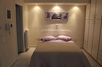 a bedroom with a bed with two pillows on it at Cozy studio apartment in PIREUS in Piraeus