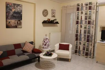 a living room with a couch and a chair at Cozy studio apartment in PIREUS in Piraeus