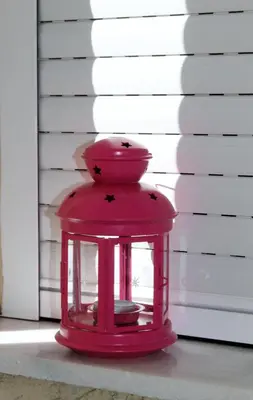 a red lantern sitting on the floor next to a wall at Cozy studio apartment in PIREUS in Piraeus