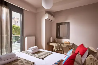 a bedroom with a bed and a desk and a window at Grystal Green Properites in Athens