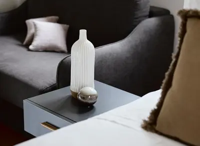 a white vase sitting on top of a table at Grystal Green Properites in Athens