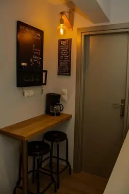 a bar in a room with two stools and a table at Comfy brand new apt near Acropolis museum in Athens
