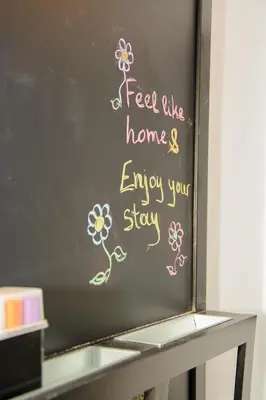 a blackboard with a sign that says feel like homes enjoy your stay at Comfy brand new apt near Acropolis museum in Athens