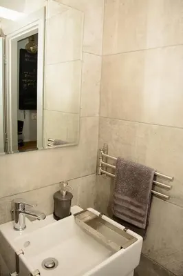a bathroom with a sink and a mirror at Comfy brand new apt near Acropolis museum in Athens